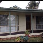 Front of house with bay window and green trim