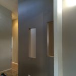 Interior wall with recessed niches and neutral paint tones.